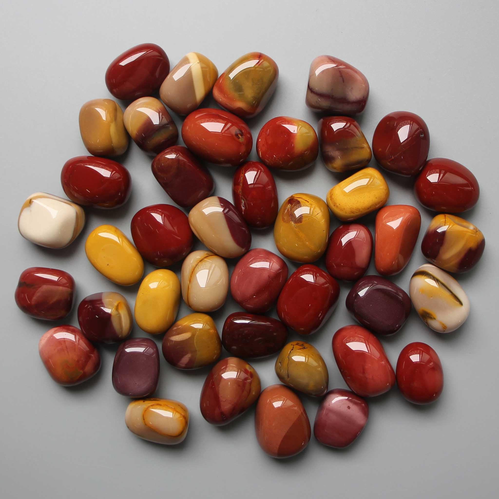 56fe4671b3ade17a77703085693cca41_c3738a89-80be-4e0c-b28c-c6ddab251859 Mookaite Tumble Stone 20/30mm A